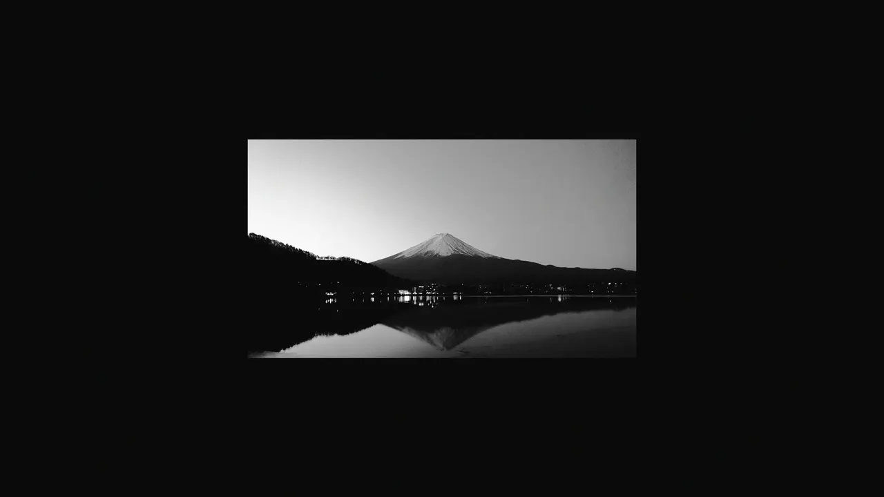 A mountain with a lake in the background