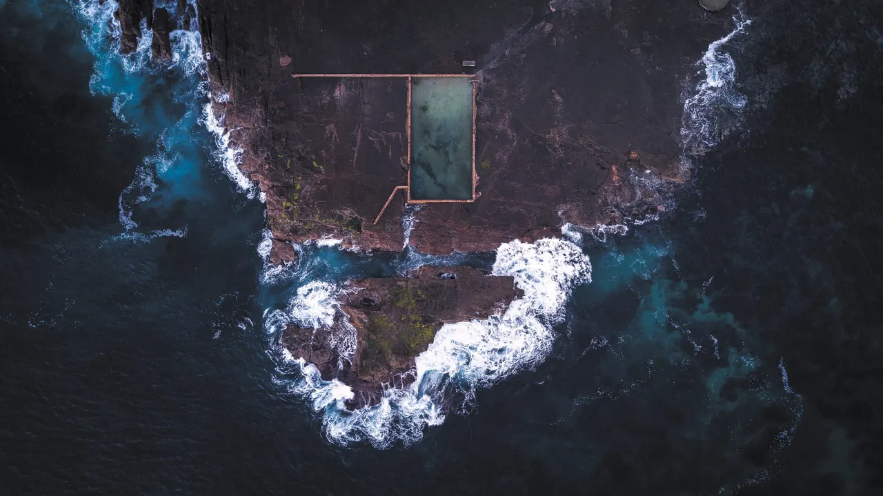 A swimming pool on a rocky island