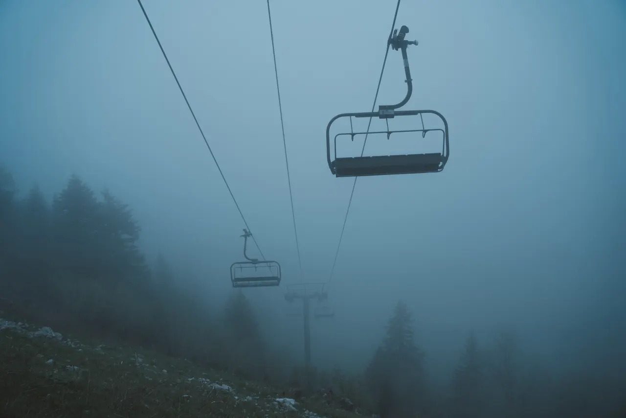 A ski lift with a chair in the air