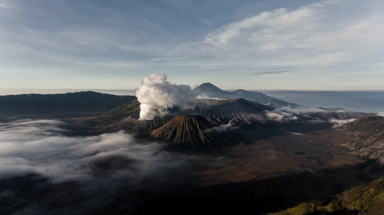 A mountain with smoke coming out of it