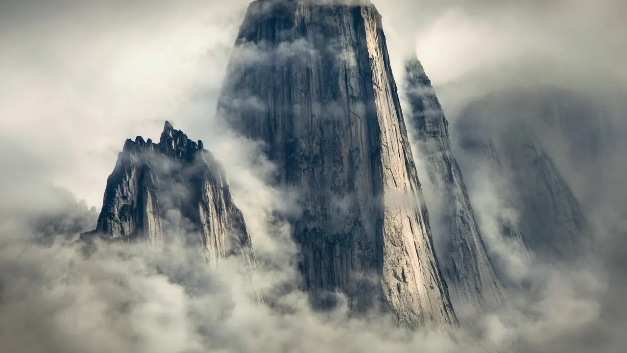 A tall mountain with clouds