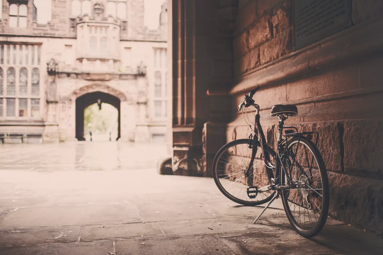 A bicycle leaning against a wall