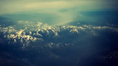 A aerial view of a snowy mountain range
