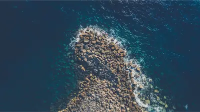 A rocky shore with waves crashing on it