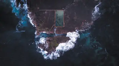 A swimming pool on a rocky island