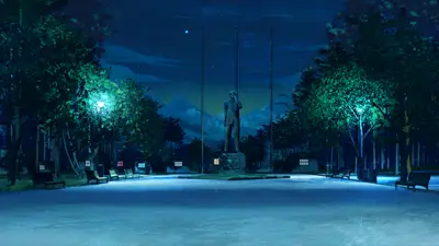 A statue of a man in a park at night