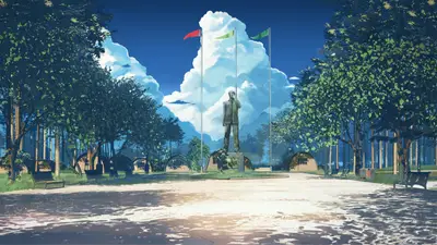 A statue of a man in a park with flags