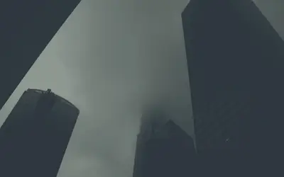 A group of tall buildings with fog