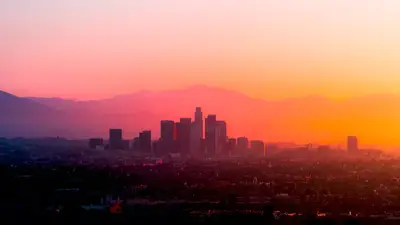 A city skyline with mountains in the background