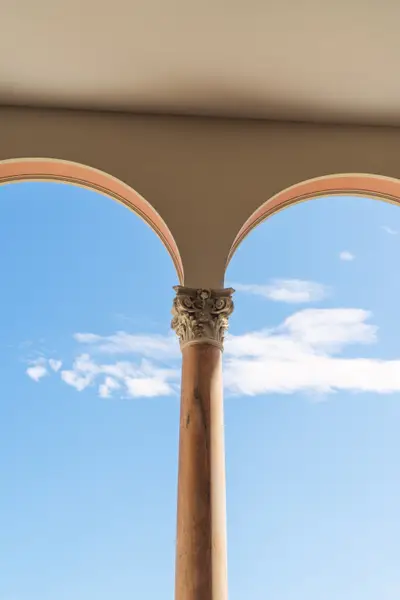 A pillar with a stone pillar and a blue sky