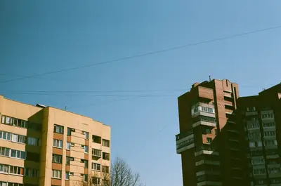 A tall buildings with power lines in the sky
