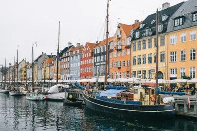 Boats in a harbor with buildings in the background