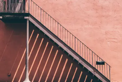 A metal staircase with a railing