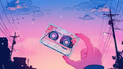 A hand holding a cassette tape