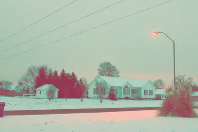 A snow covered houses and a street light
