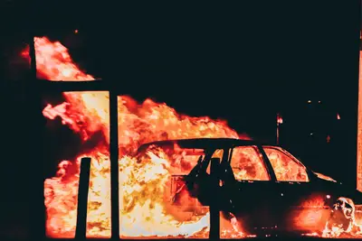 A car on fire at night