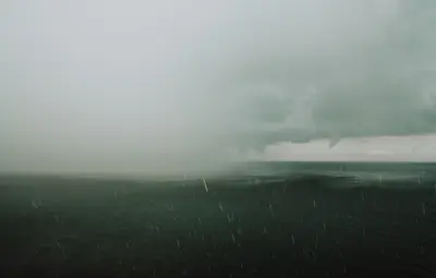 A body of water with rain falling on it