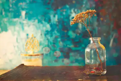 A small glass vase with a plant in it