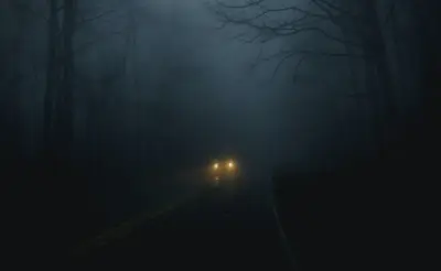 A car on a road with fog