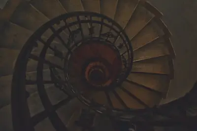 A spiral staircase with a black railing