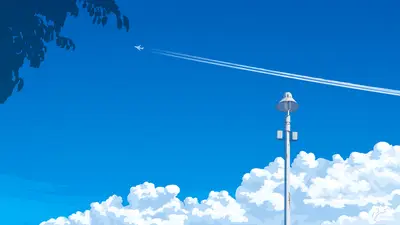 A white light pole with a jet trail in the sky