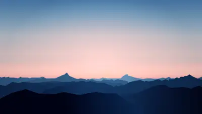 A landscape of mountains and a pink sky