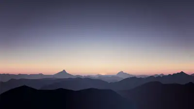 A landscape of mountains and a sunset