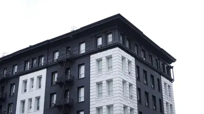 A black and white building with a fire escape