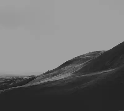 A black and white image of a hill