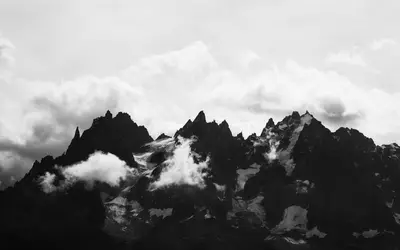 A mountain range with clouds