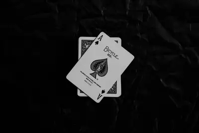 A pair of playing cards on a black surface