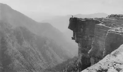 A person standing on a cliff edge