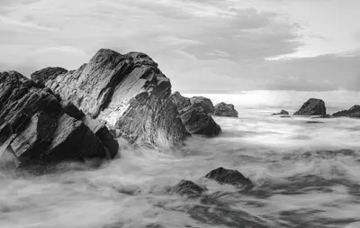 A rocky beach with waves crashing onto rocks
