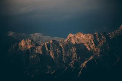 A mountain range with dark clouds
