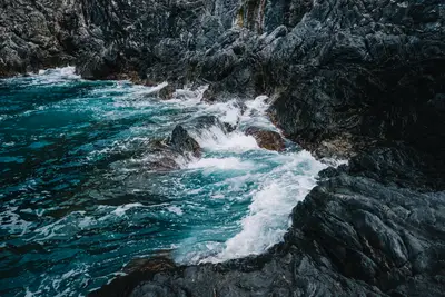 A rocky shore with waves crashing on rocks