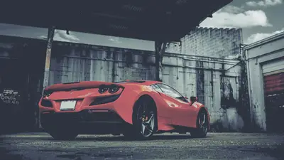 A red sports car parked in a garage