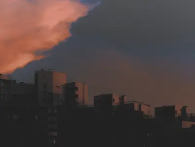 A city skyline with a sunset in the background