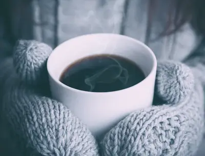 A person holding a cup of coffee